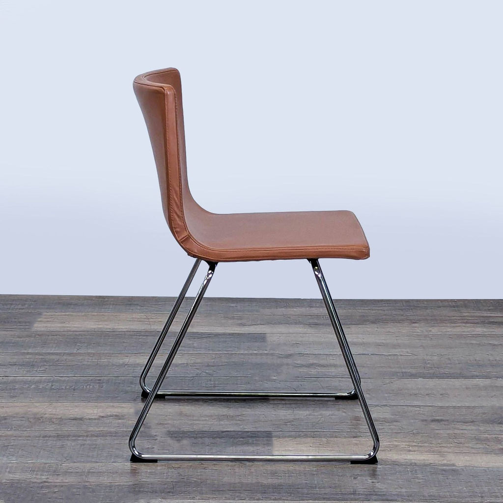 3. Side view of the Ikea Bernhard dining chair, featuring a brown leather seat and sleek chrome frame.