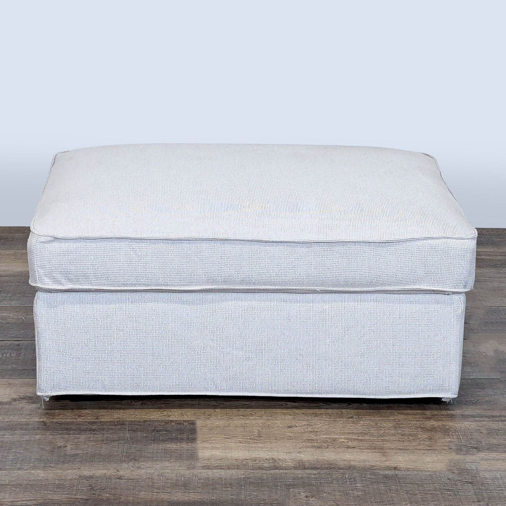 3. Front view of a rectangular light gray Ikea ottoman, part of the Stools, Ottomans & Benches category.