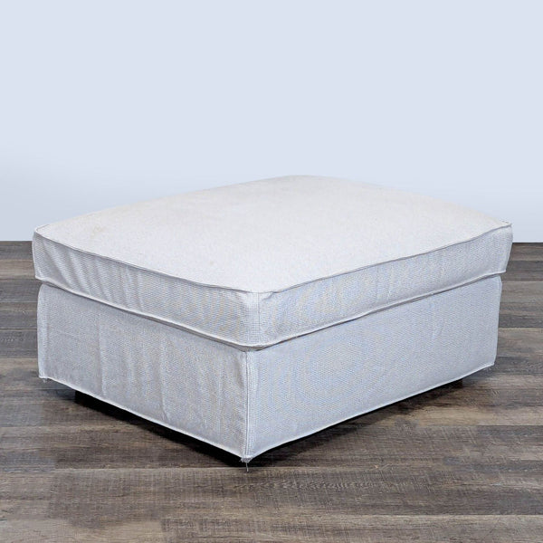 1. Light gray Ikea ottoman with a soft cushion top, shown on a wooden floor, closed and ready for seating.  