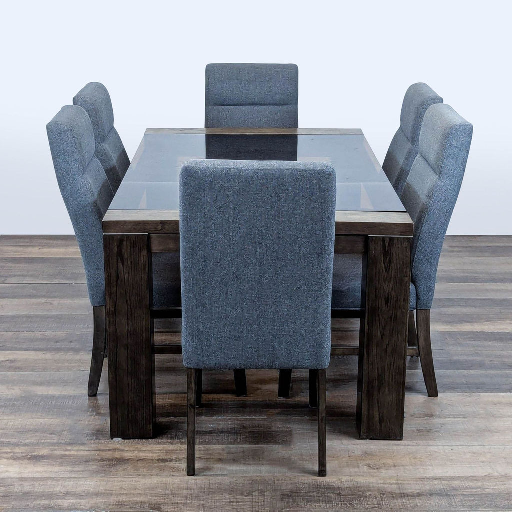 2. Six-piece Ashley dining set with gray upholstered chairs and lumbar support around a smoked glass top table.
