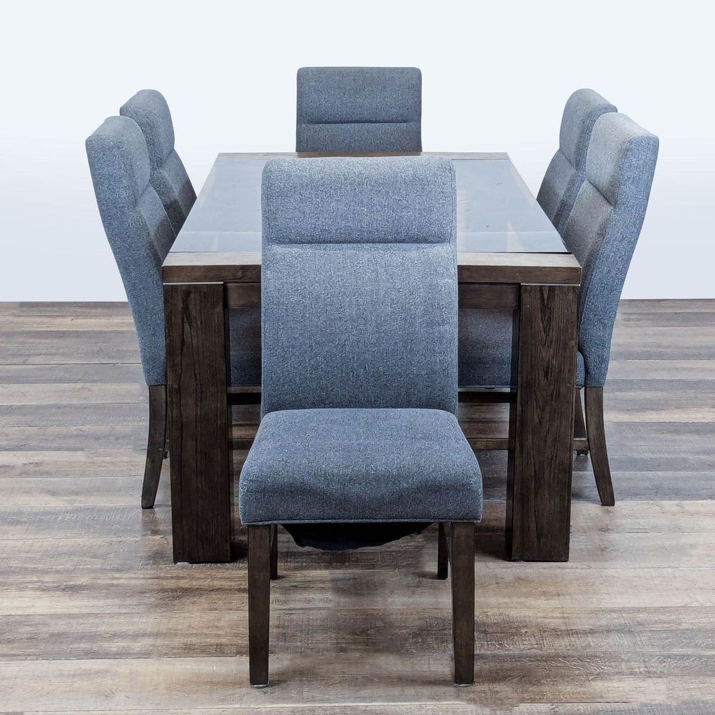 3. Ashley dining set with weathered gray table, metal accents, and six gray fabric chairs with lumbar support.