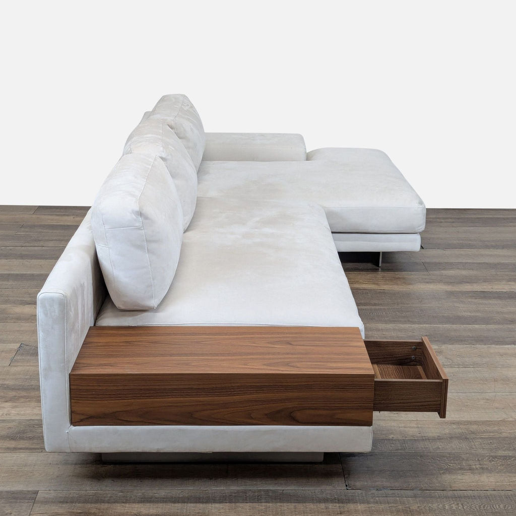 3. Close-up of Rove Concepts sectional’s walnut veneer side table, shown with an open drawer for storage.