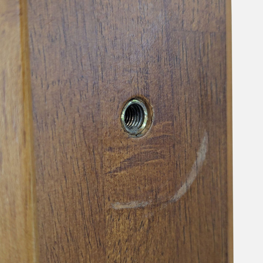 3. Close-up of Thuma frame wood showing a threaded metal insert for secure assembly and joinery.