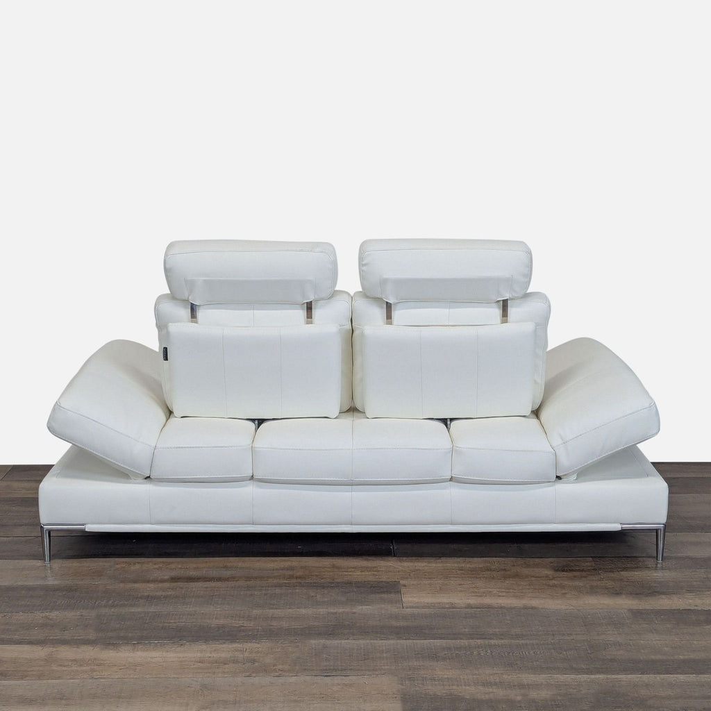 2. Modani loveseat with adjustable headrests and armrests extended, white leather, modern low design.
