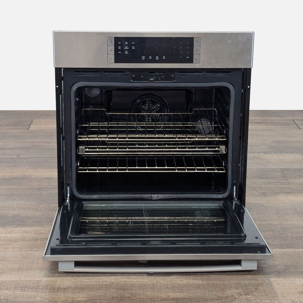 2. Open Bosch oven displaying spacious interior with racks, perfect for baking, roasting, and broiling needs.