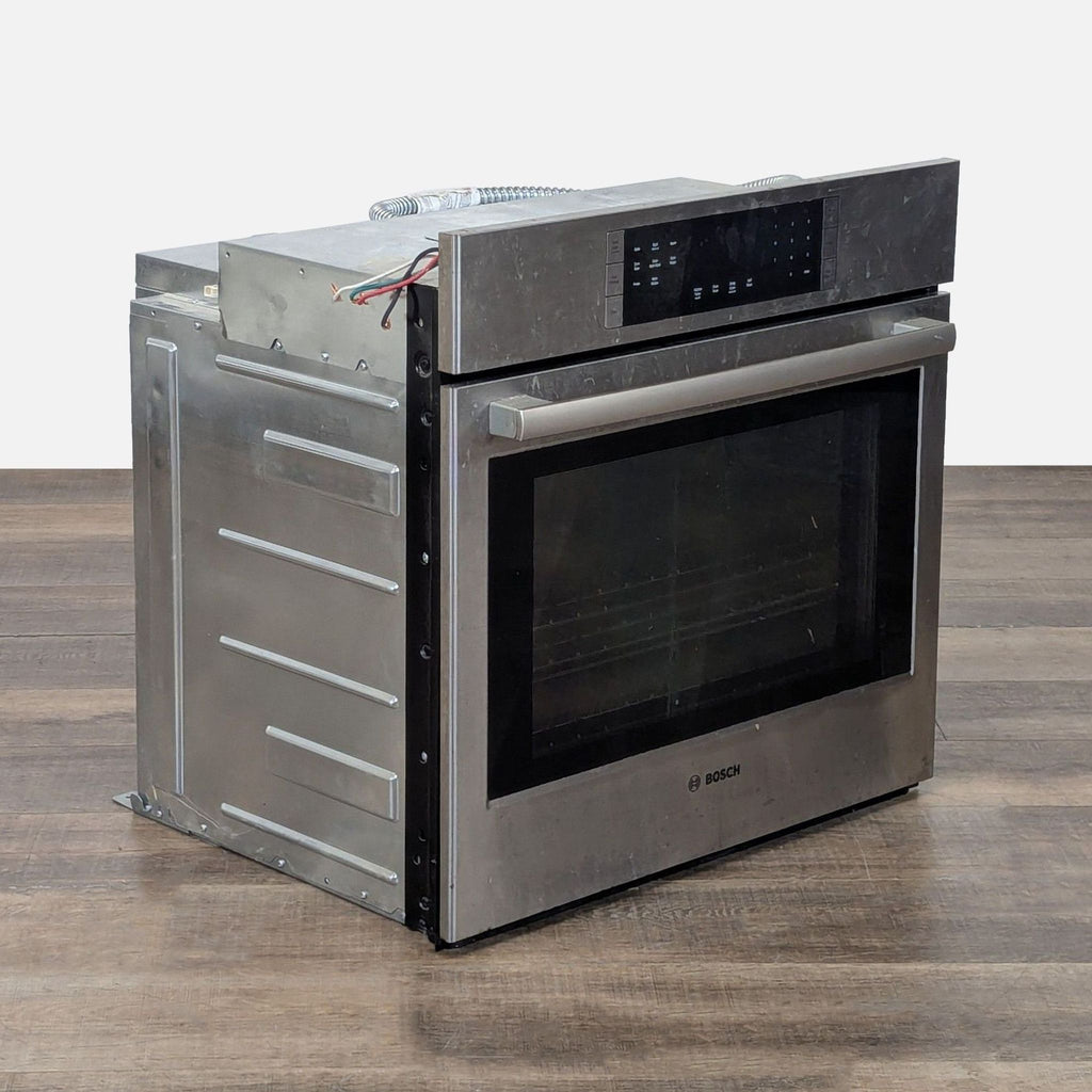 3. Angled view of Bosch electric oven showing stainless steel front, large window, and durable side panel design.