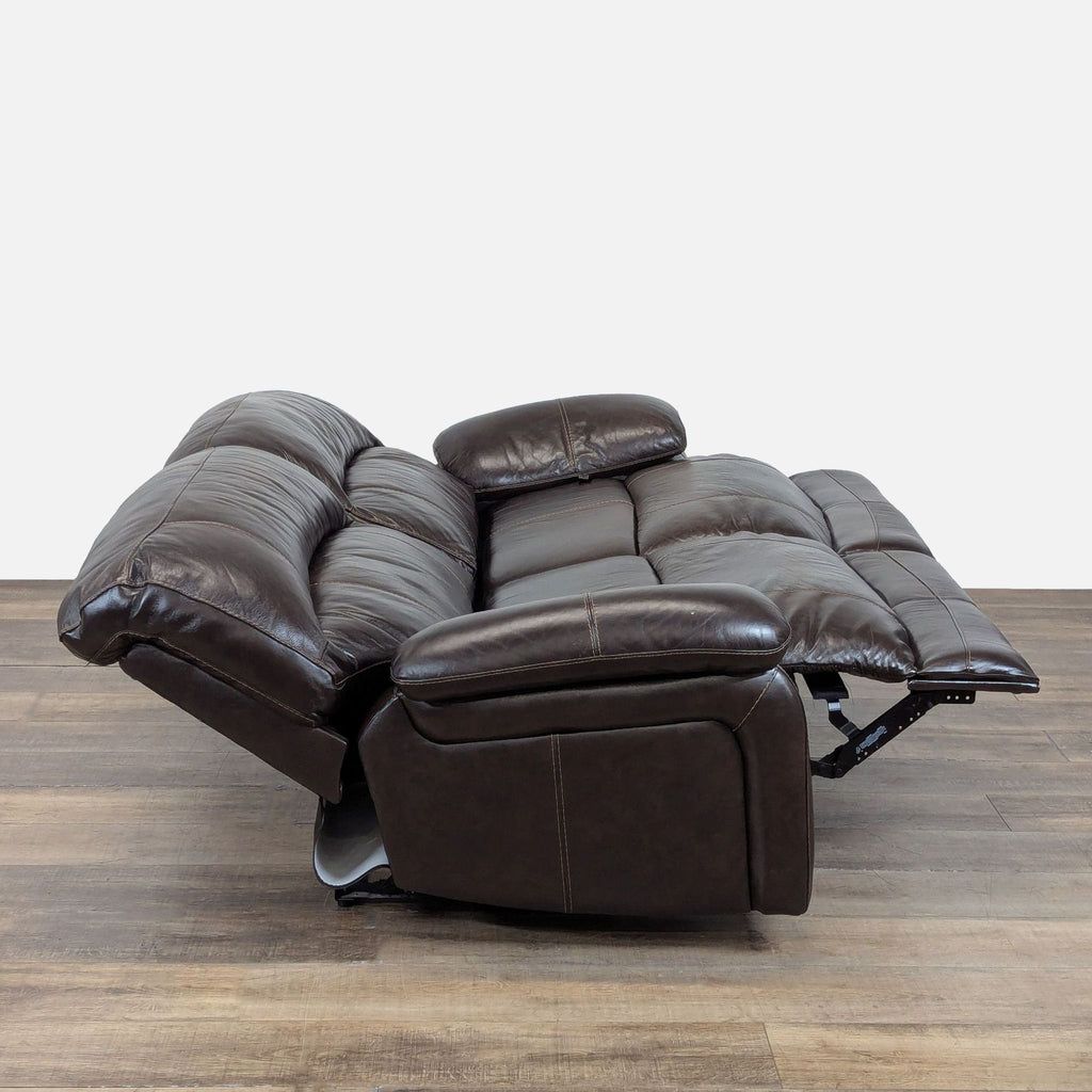 2. Side view of the Ashley Furniture loveseat fully reclined, showing plush cushioning and leather finish.