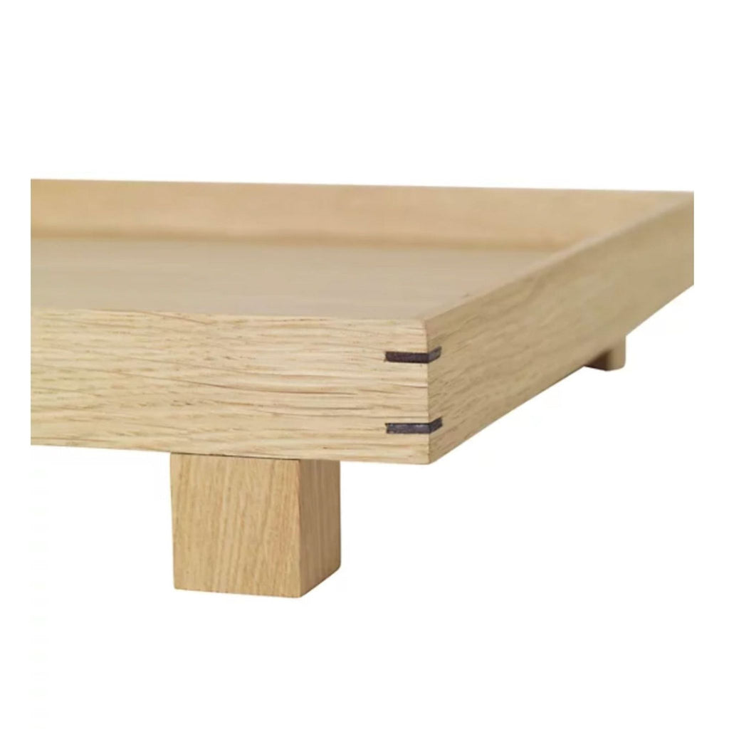 1. Close-up of a rectangular wooden tray with short legs and visible joinery, from 2Modern.