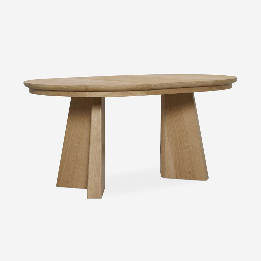 1. Oak dining table by Lulu and Georgia with two angular legs and a cross-pedestal-inspired base.  
