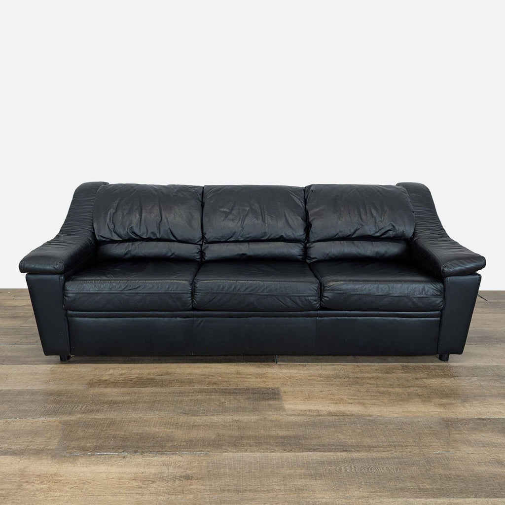 1. Front view of a Krause’s Sofa Factory black leather three-seat sleeper sofa with plush cushions.