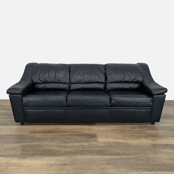 1. Front view of a Krause’s Sofa Factory black leather three-seat sleeper sofa with plush cushions.