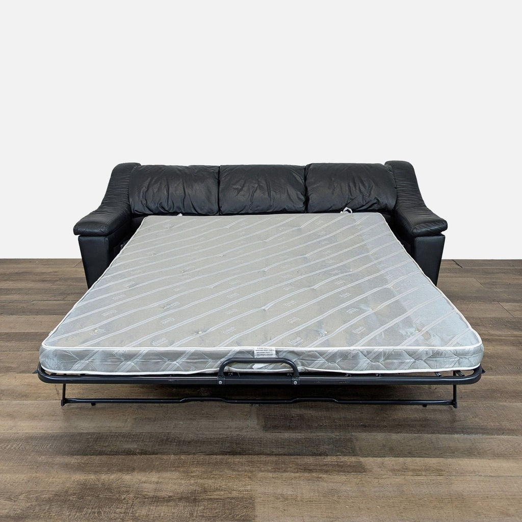 2. Krause’s Sofa Factory black leather sleeper sofa shown with pull-out bed extended.
