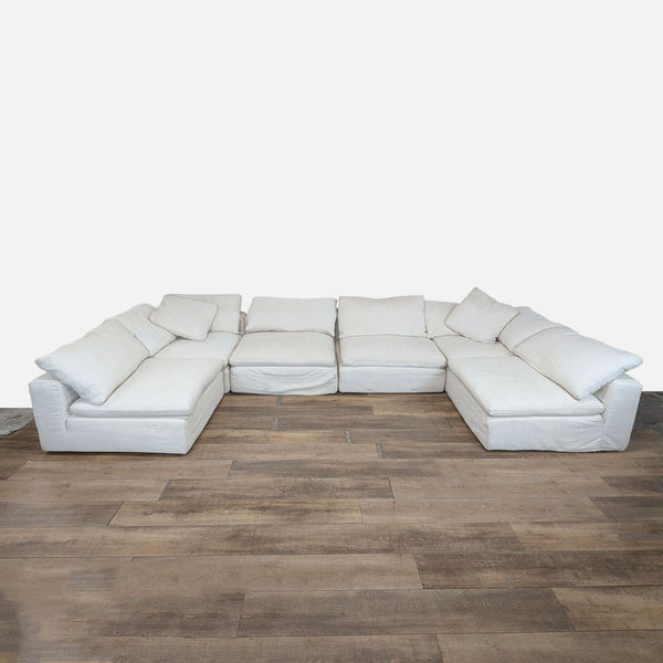 1. Large Restoration Hardware sectional sofa with wide track arms, arranged in an L-shape, on wood flooring.