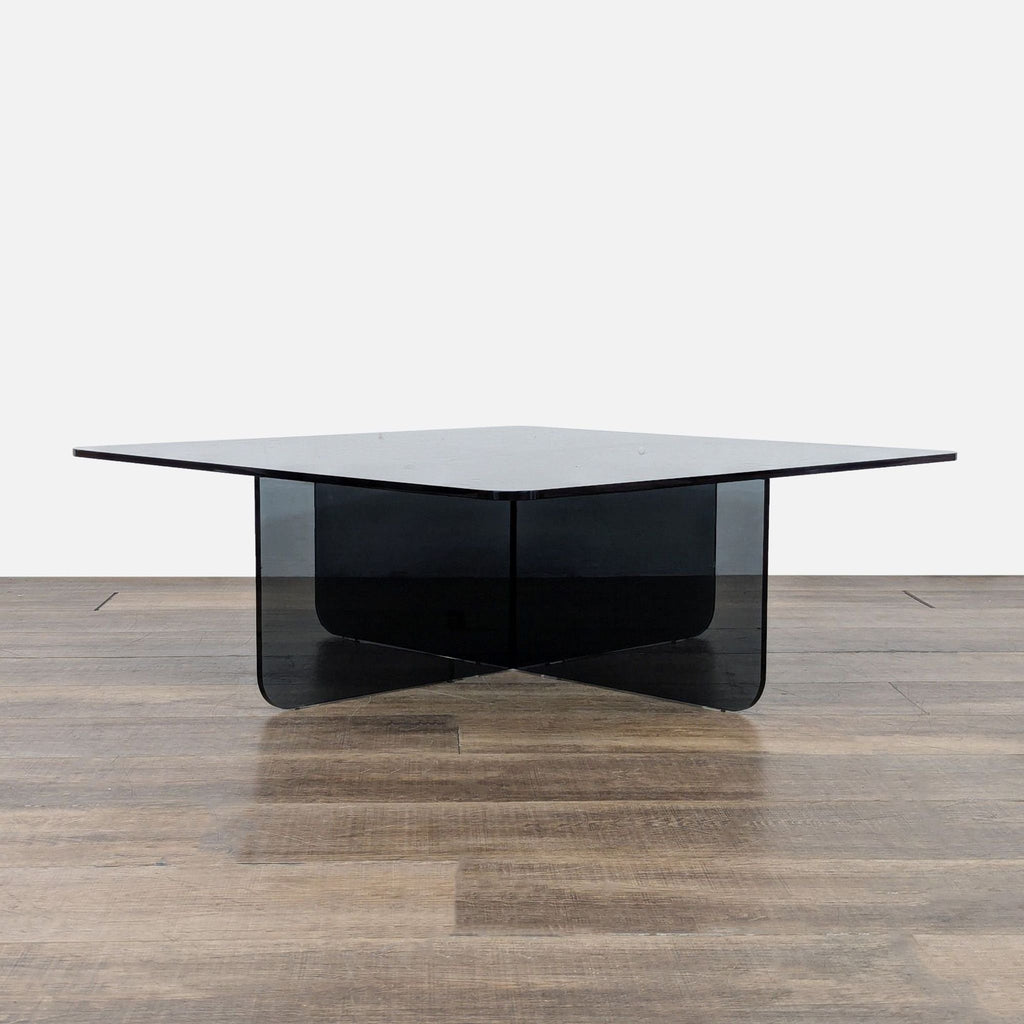 1. EQ3 coffee table with a tempered glass top and intersecting glass base, shown on a wood floor.