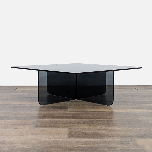 1. EQ3 coffee table with a tempered glass top and intersecting glass base, shown on a wood floor.