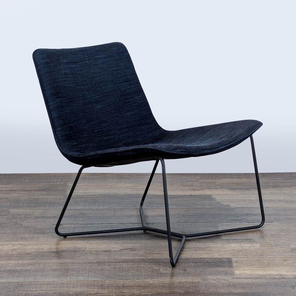 3. Angled view of West Elm lounge chair, highlighting its modern, low-slung frame and comfortable curves.