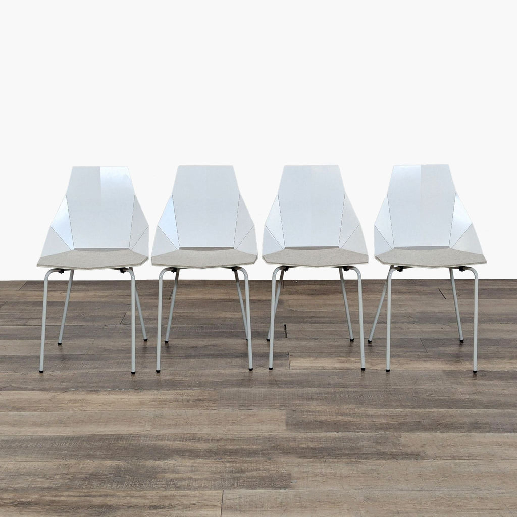 1. Set of four modern Reperch dining chairs with powder-coated steel, geometric back and Blu Dot pads, front view.