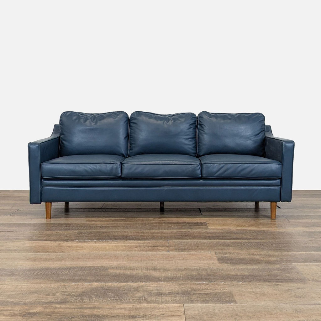 Navy blue Wayfair 3-seat sofa with faux leather upholstery and wood feet, front view.  