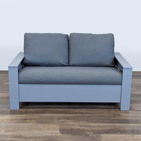 Front view of a Room & Board outdoor sofa with wide arms, grey cushions, and a durable recycled plastic frame.  