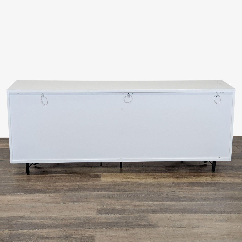 3. Back view of the Modrest sideboard featuring a plain white surface with metal rings for support.