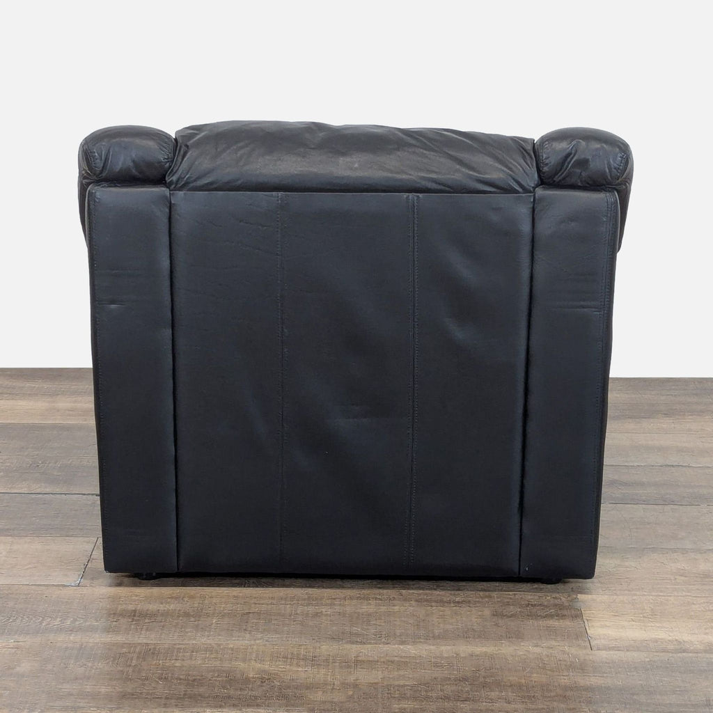 3. Rear view of a plush cushioned lounge chair with black leather upholstery from Krause’s Sofa Factory.