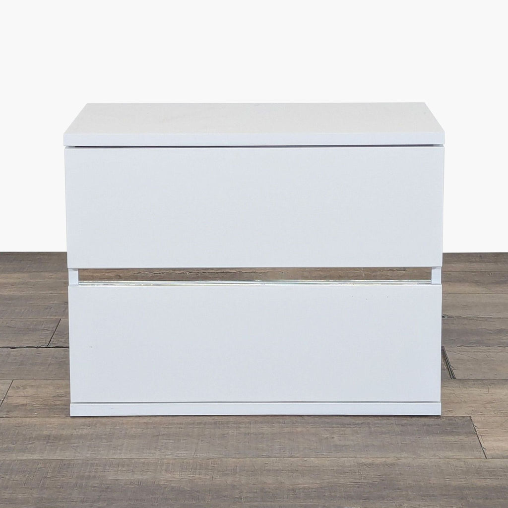 1. Front view of the Status brand end table showing its modern, white rectangular design with two drawers.  