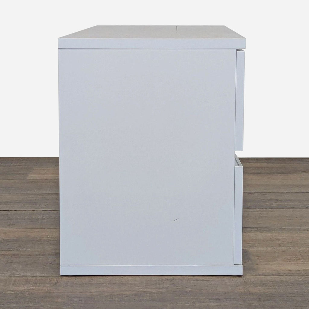 3. Side view of the Status end table, displaying a clean, minimalist white finish and partially open drawers.