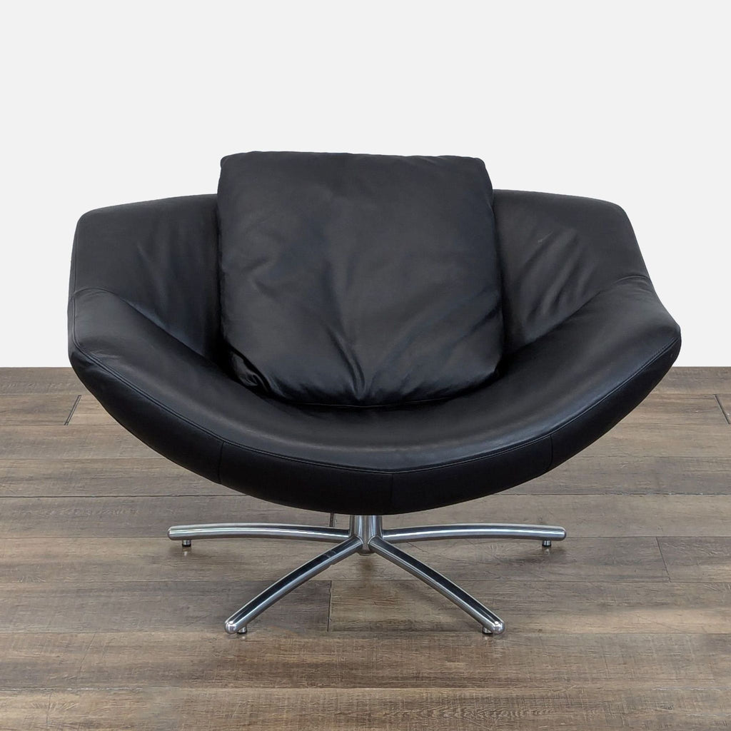 Front view of the Label GiGi lounge chair by Gerard Van Den Berg, with black Italian leather and chrome swivel base.
