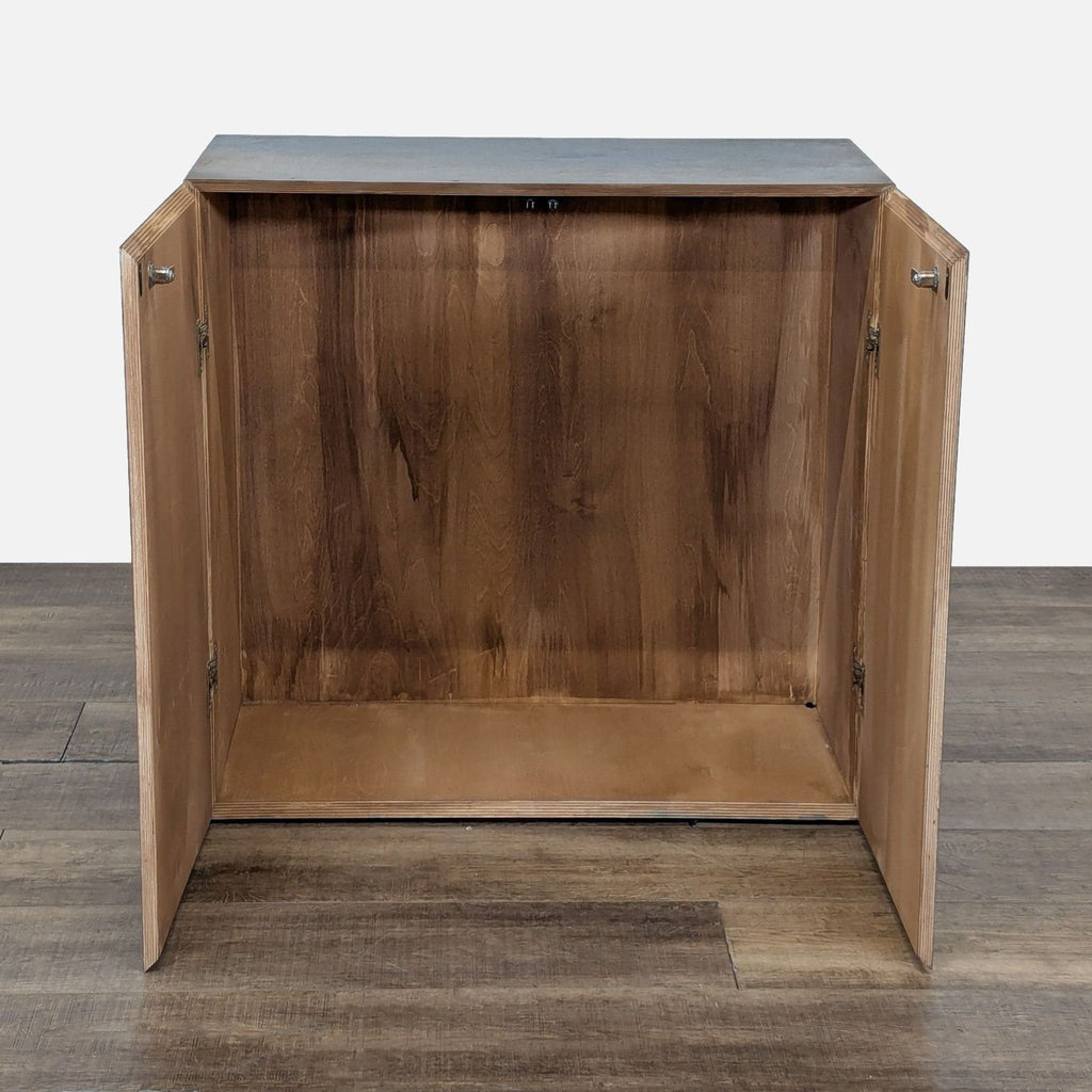 2. Interior view of the Reperch wooden cabinet, showing both doors open and the empty storage space.