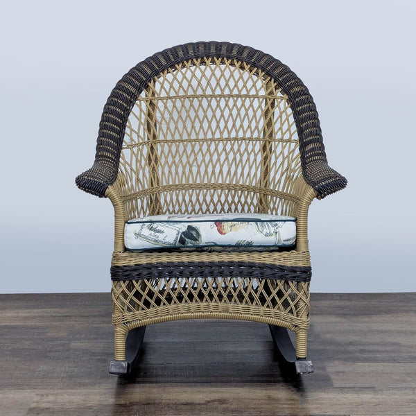 1. Front view of a two tone wicker Reperch lounge rocker with a removable printed cushion.