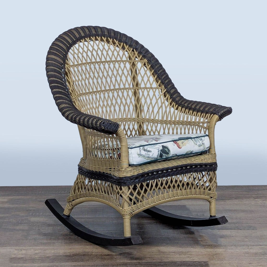 3. Angled perspective of Reperch two-tone wicker rocking lounge chair with curved arms and removable cushion.