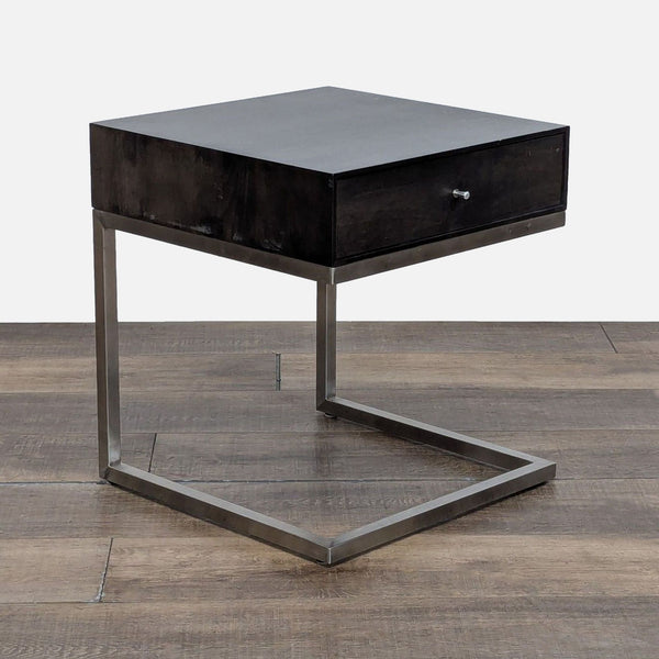 1. Modern end table by Room & Board with a single drawer and stainless steel base, closed drawer view.