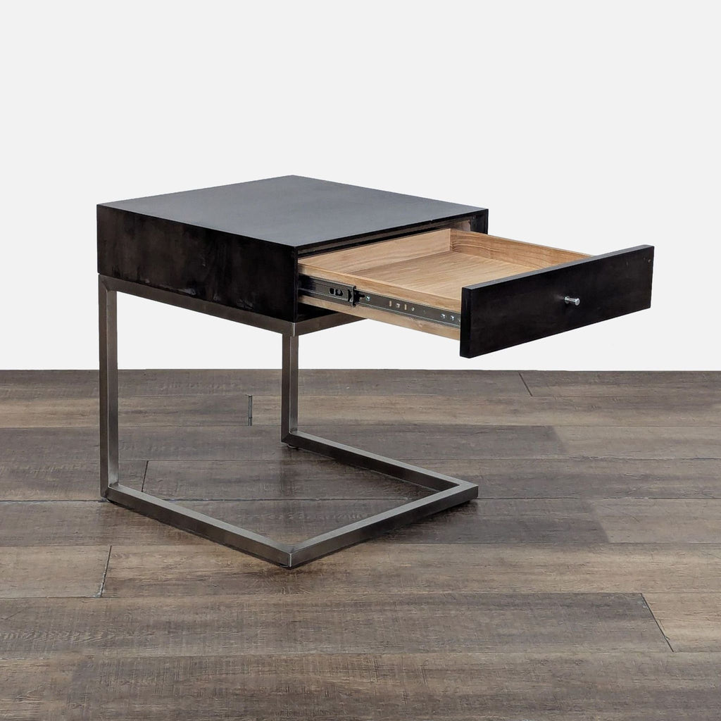 2. Room & Board black nightstand with stainless steel base, showing the open drawer for storage.