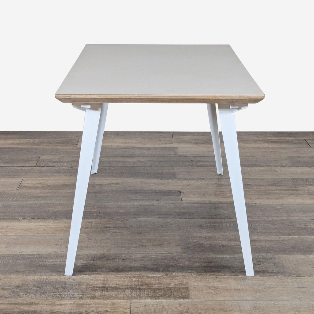 2. Minimalist Floyd dining table, powder-coated steel legs and birch plywood top, viewed from the short side.