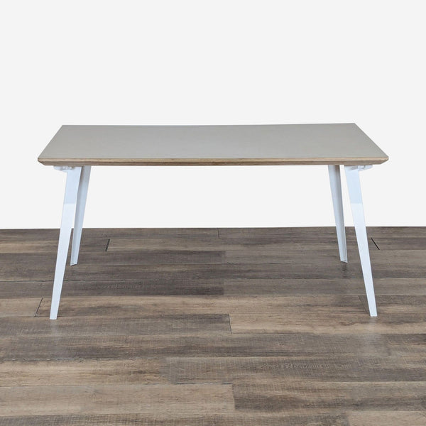 1. Floyd dining table with powder-coated steel legs and birch plywood top, shown from the front on wood flooring.