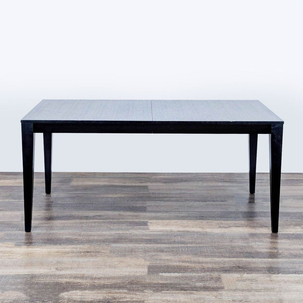 1. Rectangular Crate & Barrel dining table with ash veneer and espresso finish, shown on a wood floor.