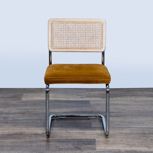 1. Front view of a Reperch cantilever dining chair with velvet seat, cane, and wood backrest.