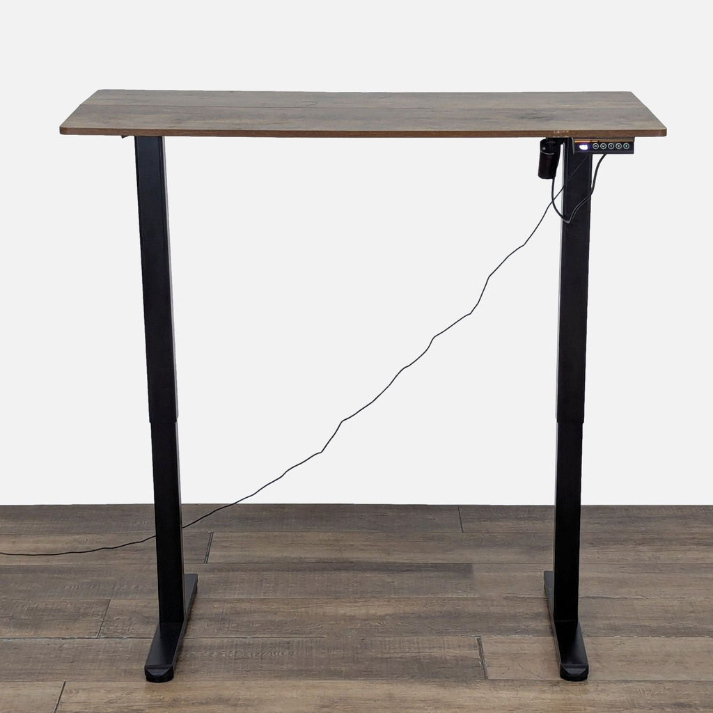 Height-adjustable Reperch desk featuring wood finish tabletop, black legs, and controller with memory presets.