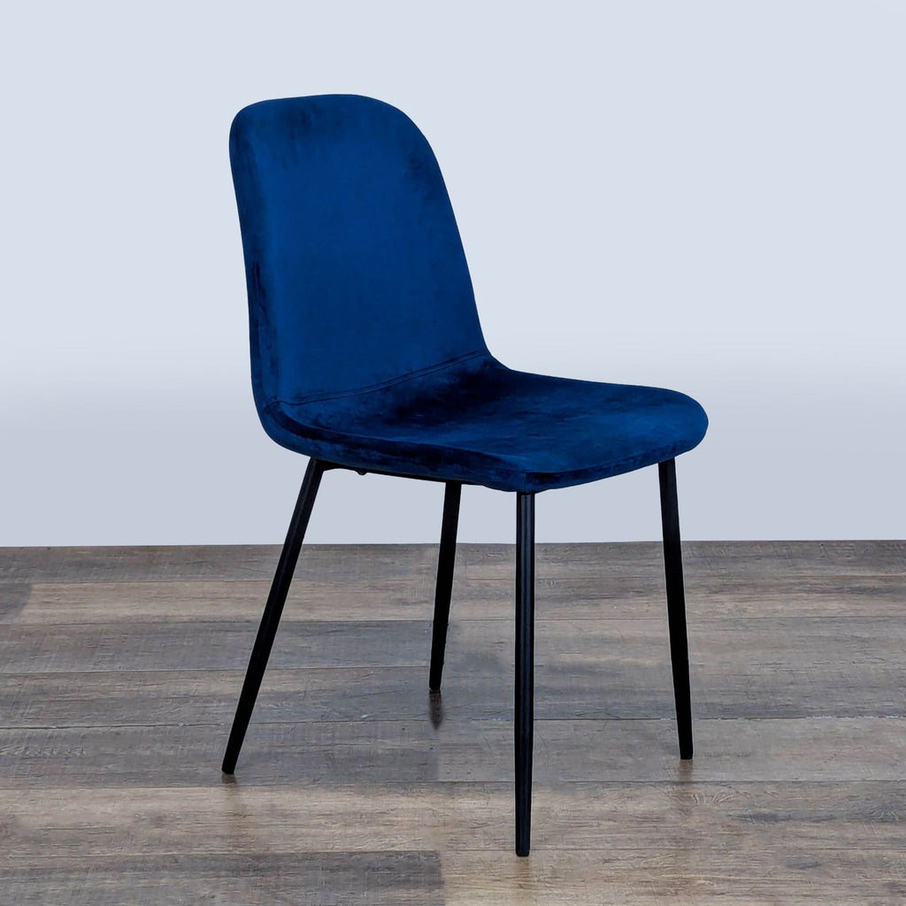 2. Blue Reperch dining chair with a curved backrest and black metal legs, angled three-quarter view.