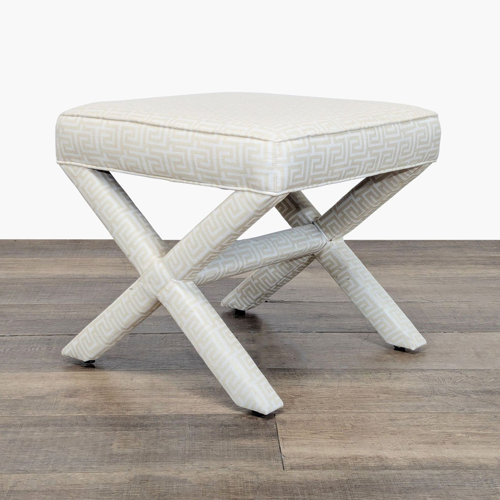 1. Square ottoman by Lee Industries with Greek key patterned fabric and X-shaped legs, shown on wood floor.