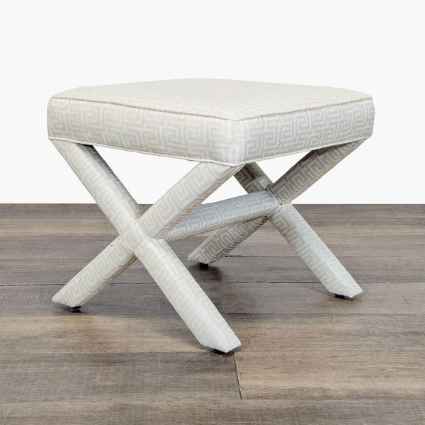 1. Square ottoman by Lee Industries with Greek key patterned fabric and X-shaped legs, shown on wood floor.