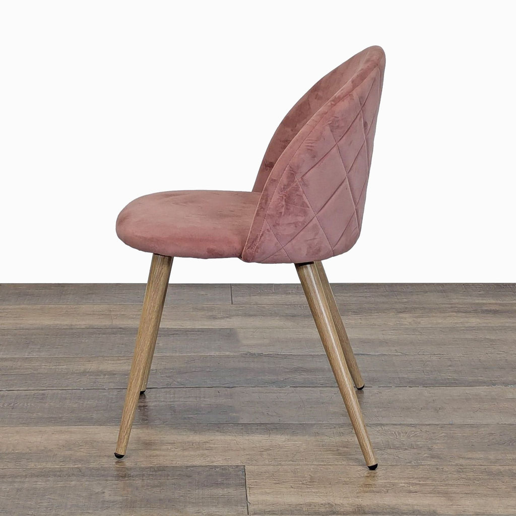 3. Side profile of a George Oliver dining chair, displaying the curved velvet back and sleek metal legs.