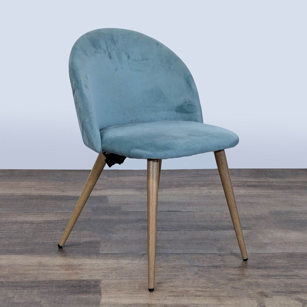 George Oliver blue velvet dining chair with metal legs, angled to show side and front profile on wood flooring.