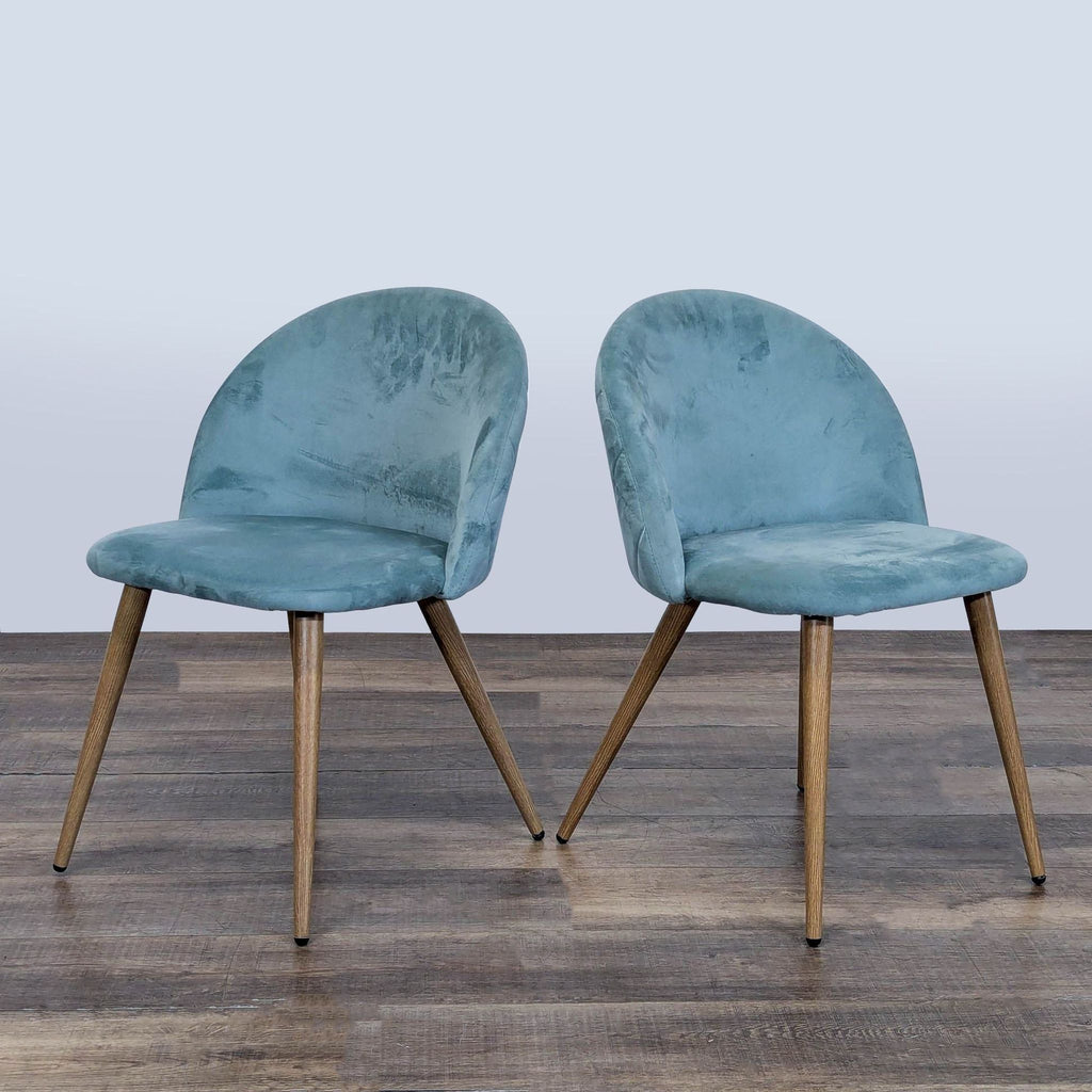 Pair of George Oliver dining chairs with blue velvet fabric and metal legs, shown on a wooden floor.