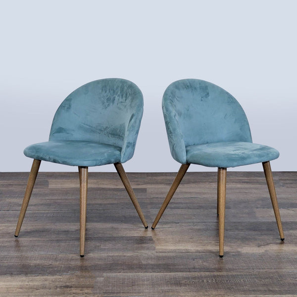 Pair of George Oliver dining chairs with blue velvet fabric and metal legs, shown on a wooden floor.