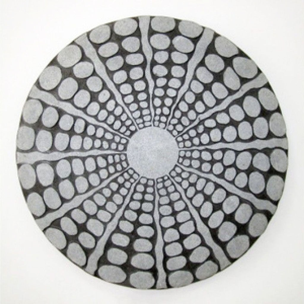 Round sandstone wall decor with a radiating pebble pattern and a stardust-polished finish.