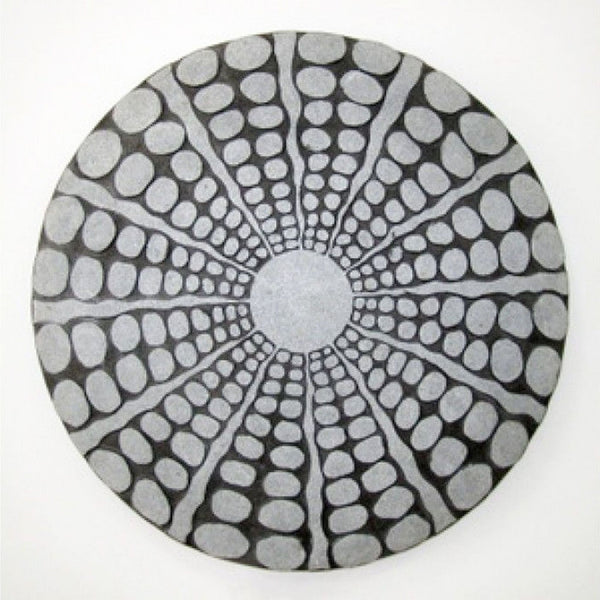 Round sandstone wall decor with a radiating pebble pattern and a stardust-polished finish.