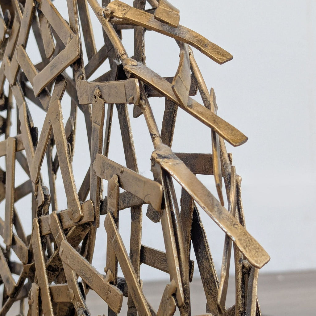 2. Close-up of the antiqued goldtone metal detailing on the geometric wild stallion sculpture from Ashley Furniture.