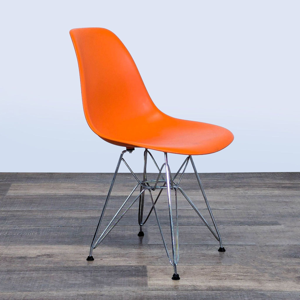2. Side-angle view of a Belnick dining chair, featuring orange molded plastic and steel legs on a wood floor.