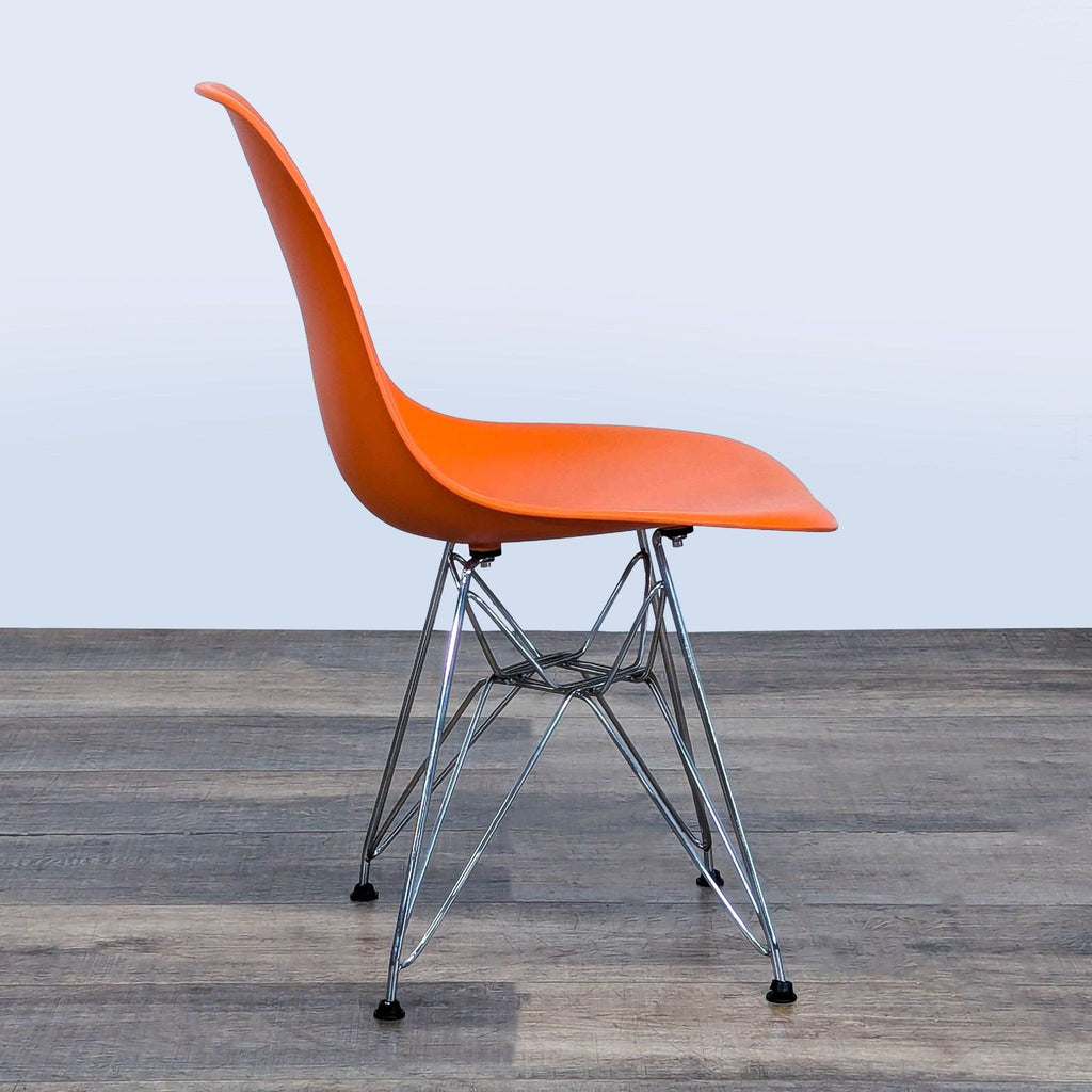 3. Profile view of an orange Belnick dining chair, molded plastic seat with steel legs, dining category.